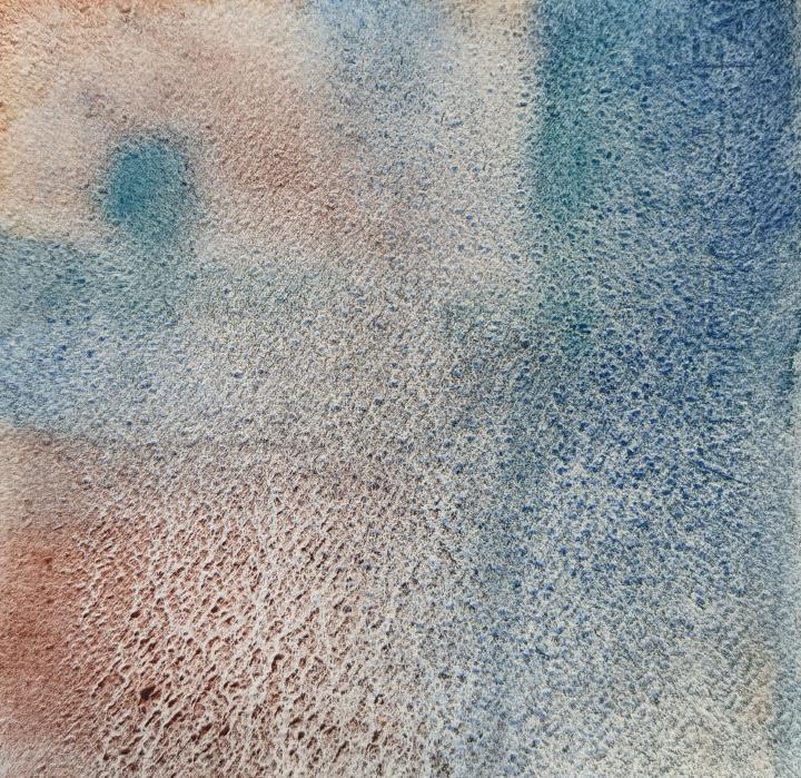 A loose watercolour of blue tree in the upper left corner, and a blue space down the right hand side, against a background of orange-brown very granulating watercolour.