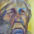 an old woman painted in bright yellows and blues