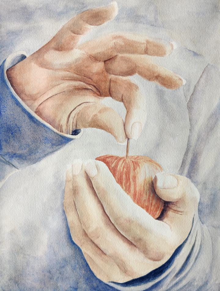 one hand holding an apple and the other pinching the stem with the fingers fanned out