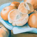 oranges, one peeled, on a blue ceramic serving dish
