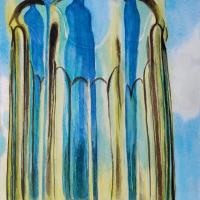 A green octagonal cup stands in front of a blue bottle and shows the refraction of the blue bottle in the column like features of the cup.